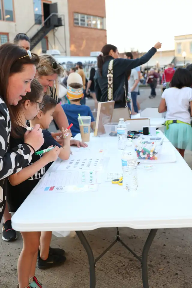 A family builds code keychains at the table