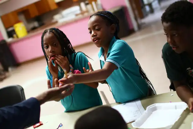 Two girls work together at the table