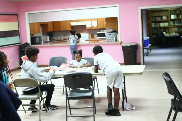 Children build at tables across the room