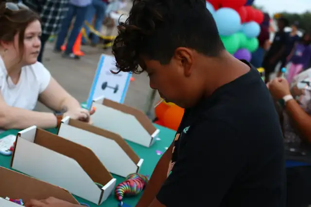 A boy builds at the challenge table
