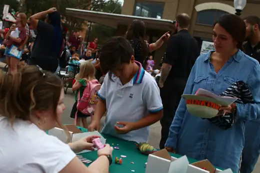 Families crowd the Byrd Zone table on a downtown street