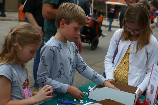 Three young builders work together at the table