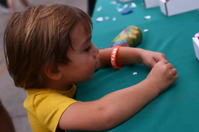 One of the youngest makers works at the table