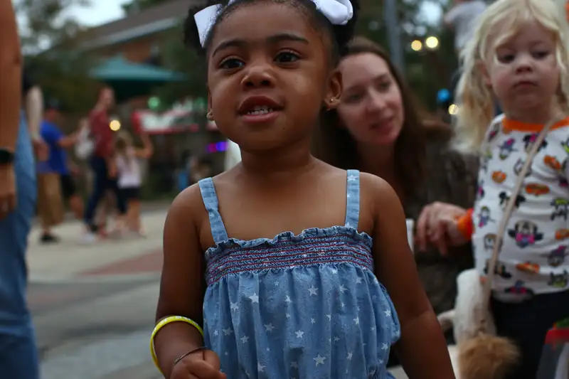 A young visitor smiles at the Byrd Zone on the street