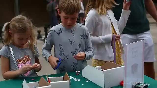 Children build at the Byrd Zone table on a festival street