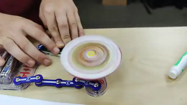 A motor spins a color wheel on a student-built circuit