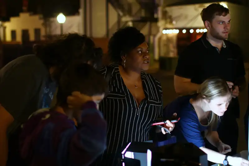 Grown-ups and children crowd the table after dark