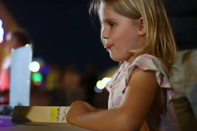 A young builder at the table after dark