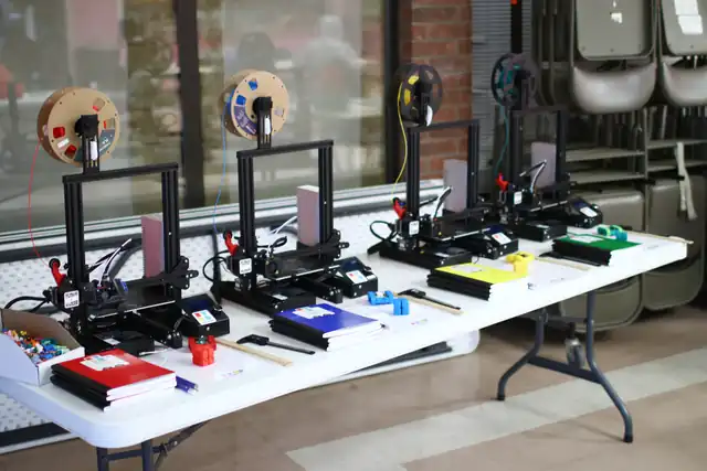 A row of 3D printers set up and ready