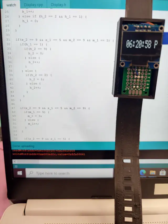 A programmed wristwatch shows the time beside its code