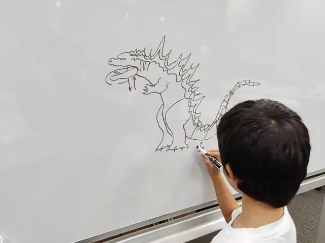 A student draws on the whiteboard