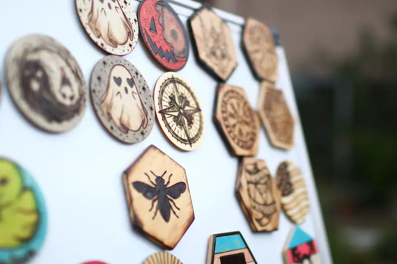 Wood-burned designs pinned to a display board